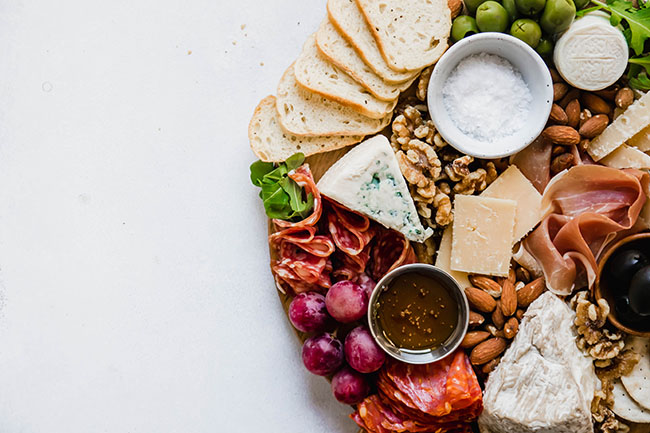 An off-center cheese board on a white background.
